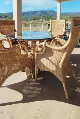 a table and chairs on a porch with a view at Villa with private pool and panoramic view in Félines-Minervois