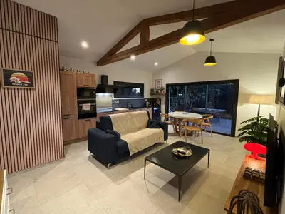 a living room with a couch and a table at Le jardin de la Vade in Carcassonne