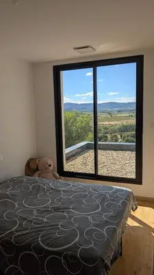 a bedroom with a bed with a large window at Oxyzenvilla 11200 Saint-André-de-Roquelongue in Saint-André-de-Roquelongue