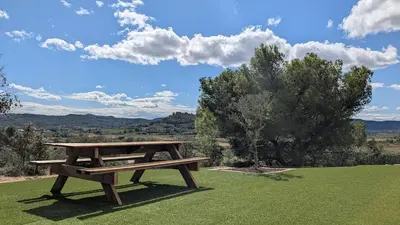 a wooden picnic table sitting on top of a field at Oxyzenvilla 11200 Saint-André-de-Roquelongue in Saint-André-de-Roquelongue