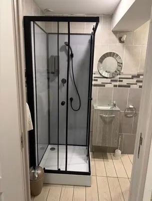 a shower with a glass door in a bathroom at Cosy Room Trèbes in Trèbes