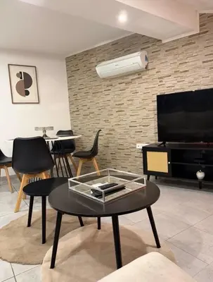 a living room with a coffee table and a flat screen tv at Cosy Room Trèbes in Trèbes