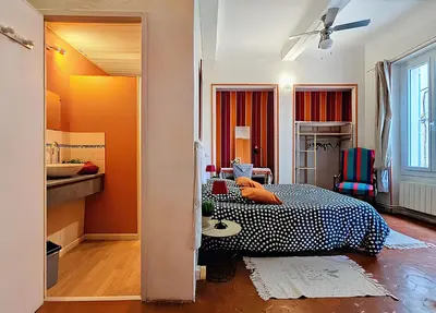 a bedroom with a bed and a sink in it at La Maison Bleue de Sigean - CHX4 in Sigean
