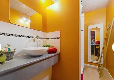 a bathroom with a sink and yellow walls at La Maison Bleue de Sigean - CHX4 in Sigean