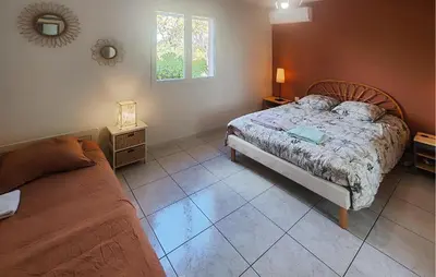 a bedroom with a bed and a couch in it at Pet Friendly Home In Saint Chinian With Wifi in Saint-Chinian