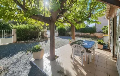 a patio with a table and chairs under a tree at Pet Friendly Home In Saint Chinian With Wifi in Saint-Chinian