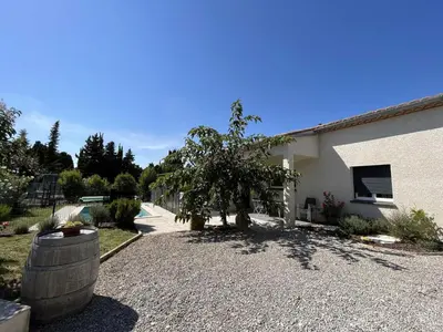 a building with a tree next to a building at Villa la garrigue in Boutenac