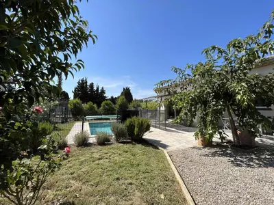 a backyard with a swimming pool and some plants at Villa la garrigue in Boutenac