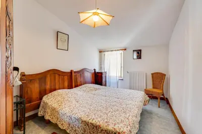 a bedroom with a bed and a chair at Chateau st-auriol - la bergerie in Lagrasse