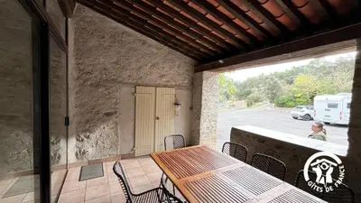 a wooden table and chairs on a patio at Chateau st-auriol - la bergerie in Lagrasse