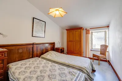 a bedroom with a bed and a dresser and a window at Chateau st-auriol - la bergerie in Lagrasse