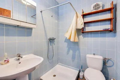 a blue tiled bathroom with a toilet and a sink at Chateau st-auriol - la bergerie in Lagrasse