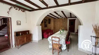 a dining room with a table and a red couch at Chateau st-auriol - le caviste in Lagrasse