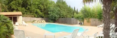 a swimming pool with white chairs and a fence at Chateau st-auriol - magnanerie in Lagrasse