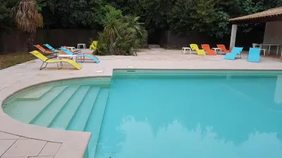 a swimming pool with chairs and a table and chairs at Chateau st-auriol - magnanerie in Lagrasse