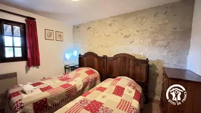 a bedroom with two beds and a table and window at Chateau st-auriol - magnanerie in Lagrasse