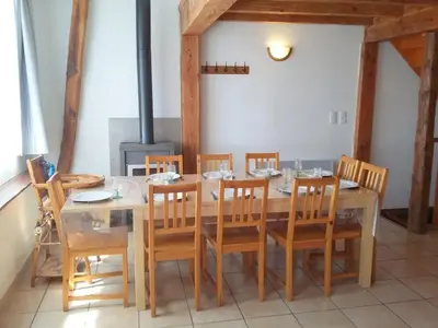 a dining room with a table and wooden chairs at Maison accueillante à Le Soulié avec jardin in Le Soulié