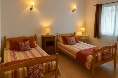 a bedroom with two beds and two lamps and a window at Maison accueillante à Le Soulié avec jardin in Le Soulié