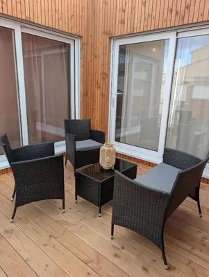 a balcony with chairs and a table and windows at Localodge in Caves