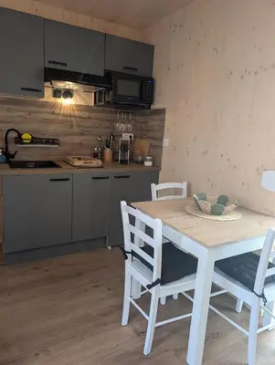 a kitchen with a table and chairs in a kitchen at Localodge in Caves