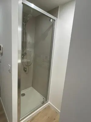 a shower with a glass door in a bathroom at Maison de ville rénovée - Carc'apparts - terrasse in Carcassonne