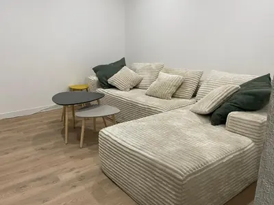 a living room with a couch and a table at Maison de ville rénovée - Carc'apparts - terrasse in Carcassonne