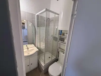 a bathroom with a shower and a toilet and a sink at Appartement Studio Cabine Mezzanine 4 couchages- PORT-LA NOUVELLE PN290-031 in Port-la-Nouvelle