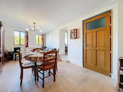a dining room with a table and chairs and a door at Le poli - 6 pers - Centre - vue sur la cathédrale in Narbonne