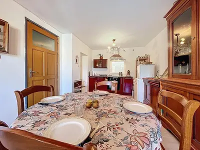 a kitchen with a table with plates on it at Le poli - 6 pers - Centre - vue sur la cathédrale in Narbonne