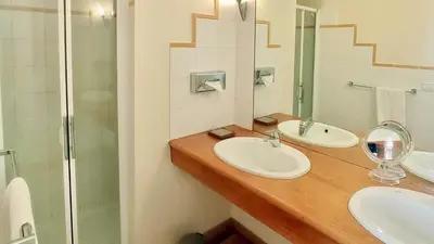 a bathroom with two sinks and a shower at Gite Charles de Castres in Saint-Affrique-les-Montagnes