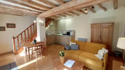 a living room with a couch and a table at Gite Charles de Castres in Saint-Affrique-les-Montagnes