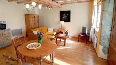 a living room with a table and a couch at Gite Charles de Castres in Saint-Affrique-les-Montagnes