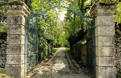 an entrance to a garden with an iron gate at Gite Charles de Castres in Saint-Affrique-les-Montagnes