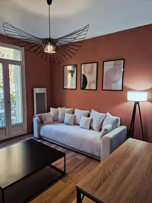a living room with a couch and a table at Studio, centre-ville Narbonne in Narbonne
