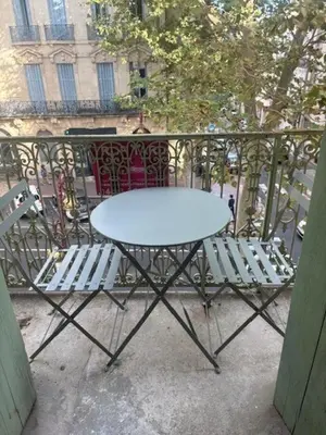 a white table and chairs on a balcony at Studio, centre-ville Narbonne in Narbonne
