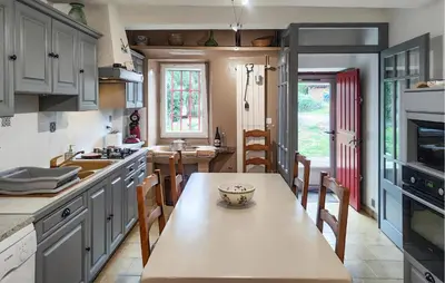 a kitchen with a table with a bowl on it at 2 Bedroom Awesome Home In Pardailhan in Pardailhan
