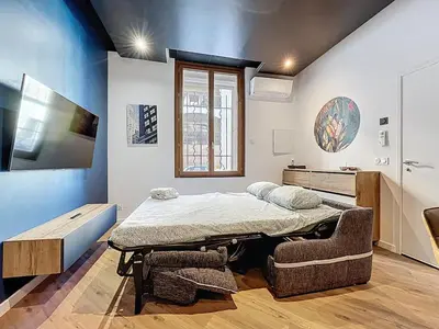a room with a bed and a table in it at la loge des halles - clim - 50m des halles in Narbonne