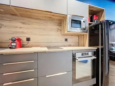 a kitchen with a refrigerator and a microwave at la loge des halles - clim - 50m des halles in Narbonne