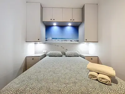 a bedroom with a bed with two towels on it at la loge des halles - clim - 50m des halles in Narbonne