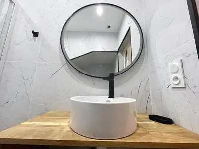 a white sink with a mirror on top of it at la loge des halles - clim - 50m des halles in Narbonne