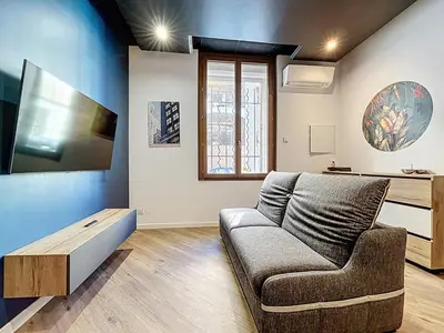 a living room with a couch and a table at la loge des halles - clim - 50m des halles in Narbonne