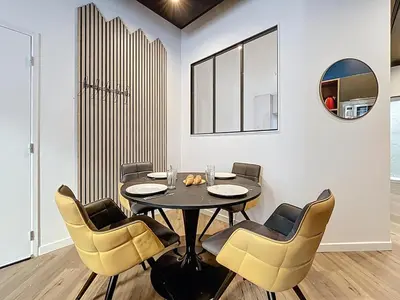 a dining room with a table and chairs at la loge des halles - clim - 50m des halles in Narbonne