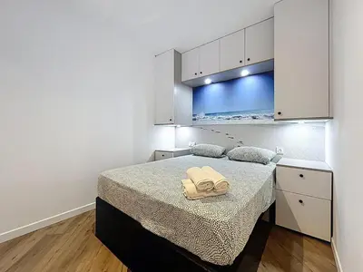 a bedroom with a bed with two towels on it at la loge des halles - clim - 50m des halles in Narbonne