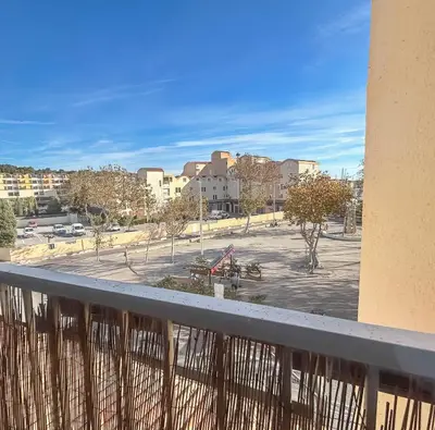 a view of a parking lot from a balcony at Studio Cabine En Bord De Mer à Gruissan in Gruissan