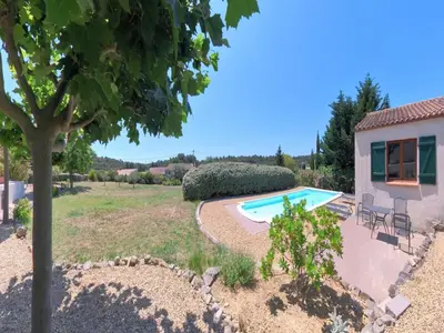 a garden with a pool and a house at Relaxing Retreat Near Minerve in Aigne
