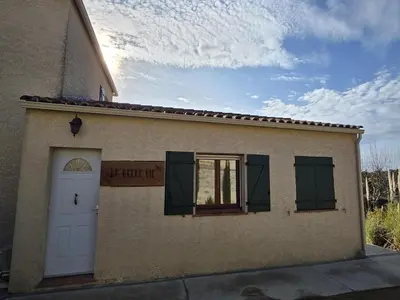 a small house with a white door and windows at Relaxing Retreat Near Minerve in Aigne