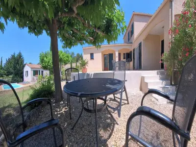 a patio with a table and chairs in front of a house at Relaxing Retreat Near Minerve in Aigne