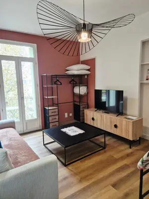 a living room with a couch and a table at Cosy studio, centre ville Narbonne in Narbonne