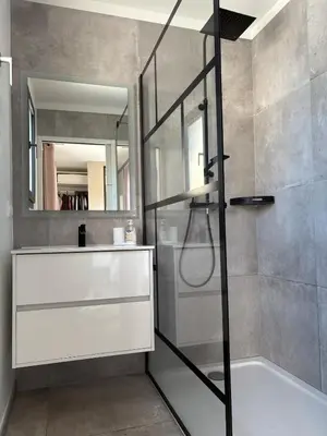a bathroom with a shower with a glass door at La villa du soleil in Lapalme