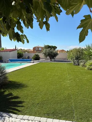 a yard with a swimming pool and a lawn at La villa du soleil in Lapalme
